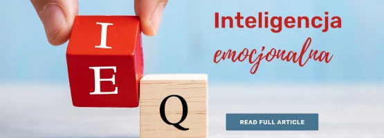 Dłoń układająca drewniane klocki z literami, obok napis „Inteligencja emocjonalna”